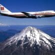 a plane flying over a mountain