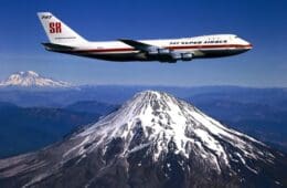 a plane flying over a mountain