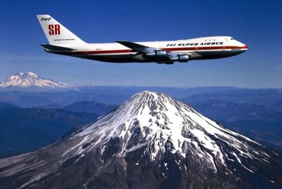 a plane flying over a mountain