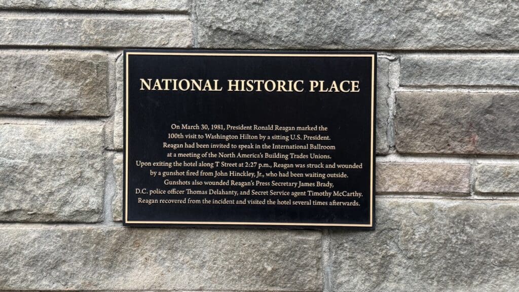 a sign on a stone wall