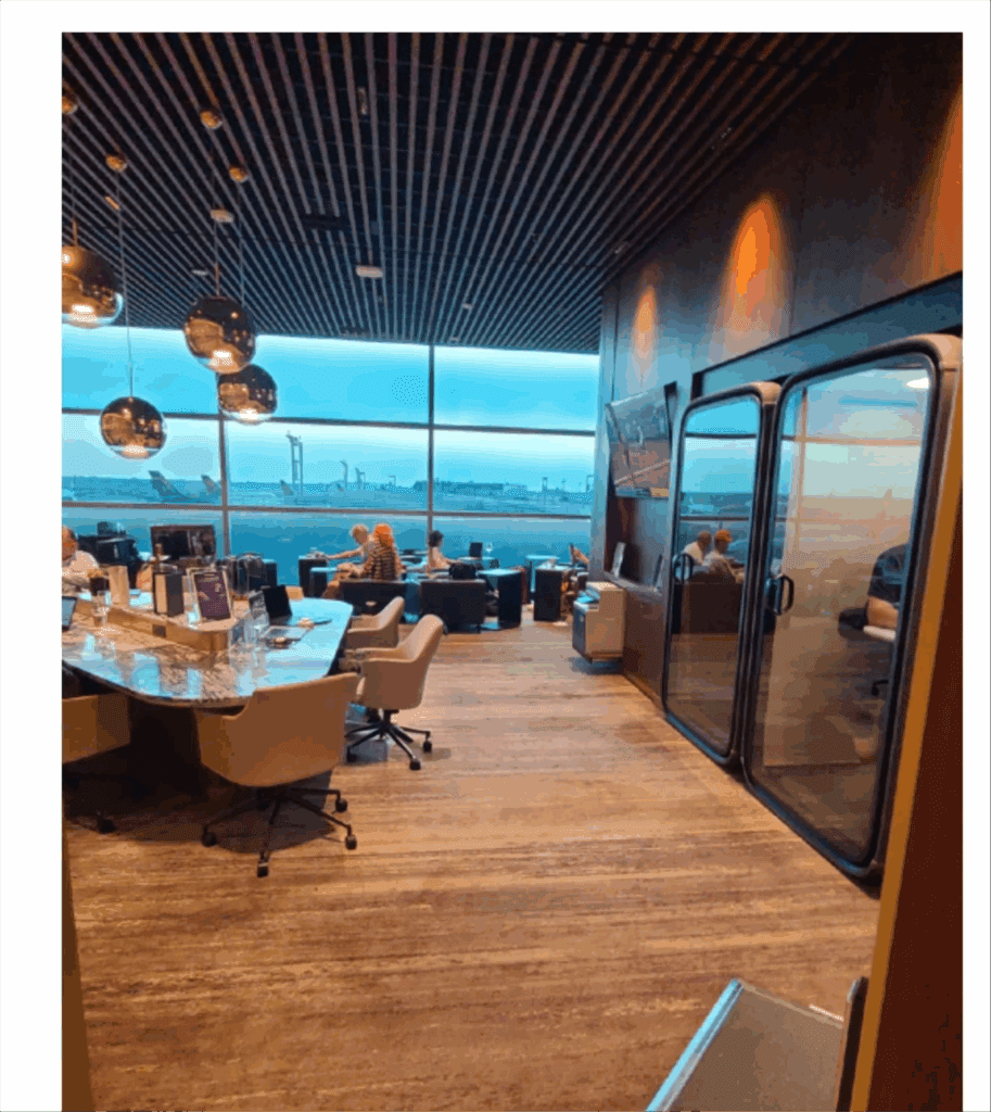 a room with a large window and a table with chairs and a large glass door
