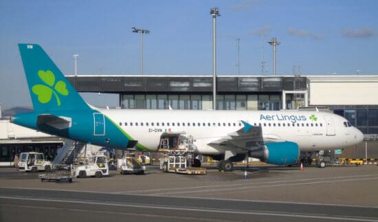 a white and blue airplane at an airport