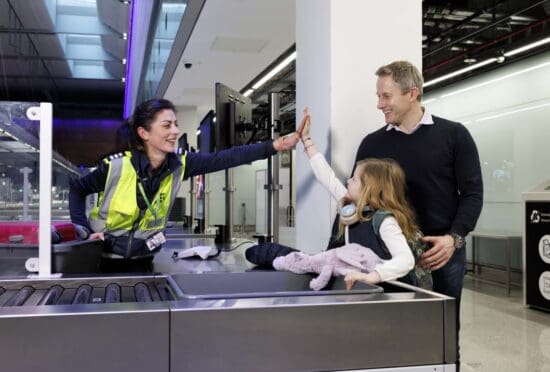 a man and woman giving a high five to a child