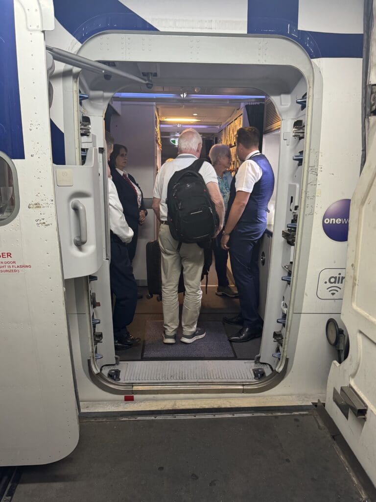 a group of people standing in a doorway of a vehicle