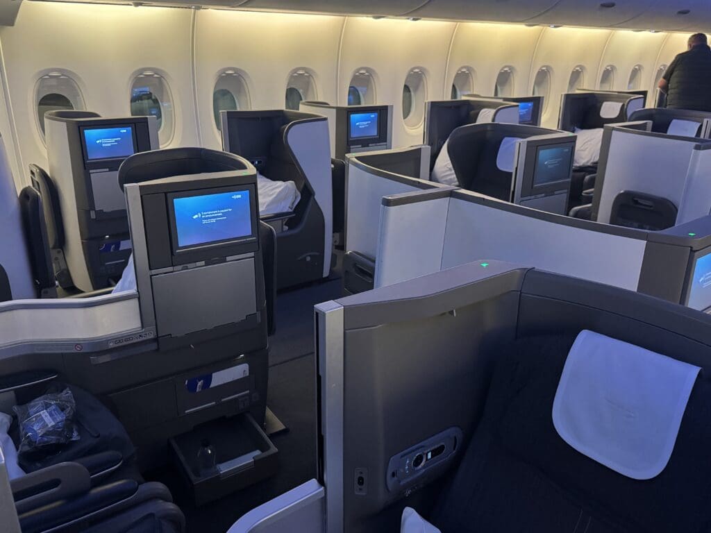 a row of seats with tvs on the side