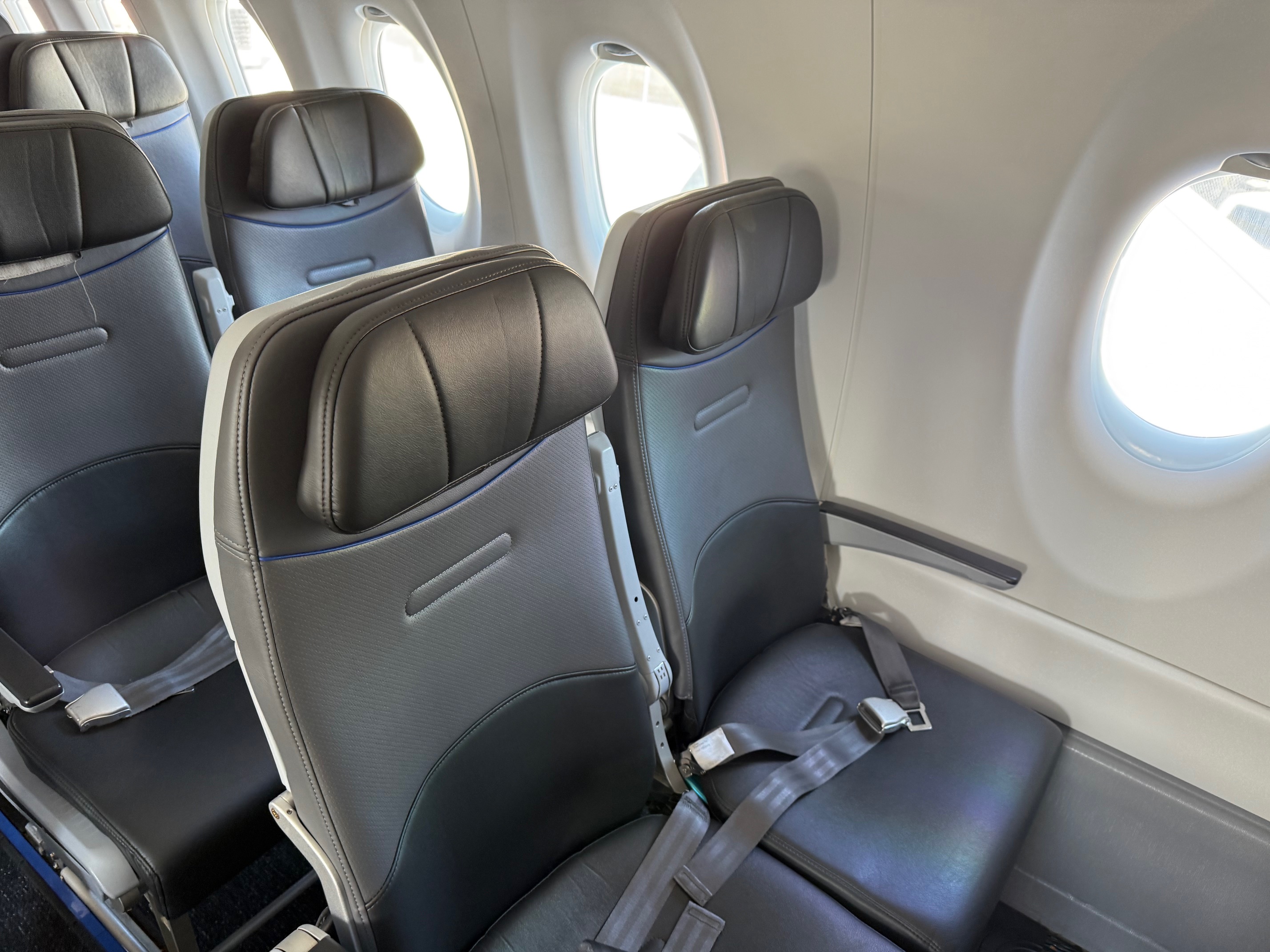 a row of seats in an JetBlue Airbus A220