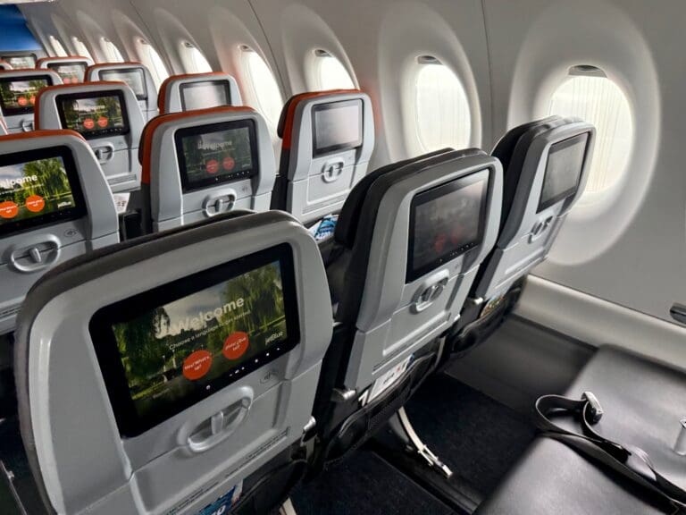 a row of seats in a JetBlue Airbus A220 aircraft