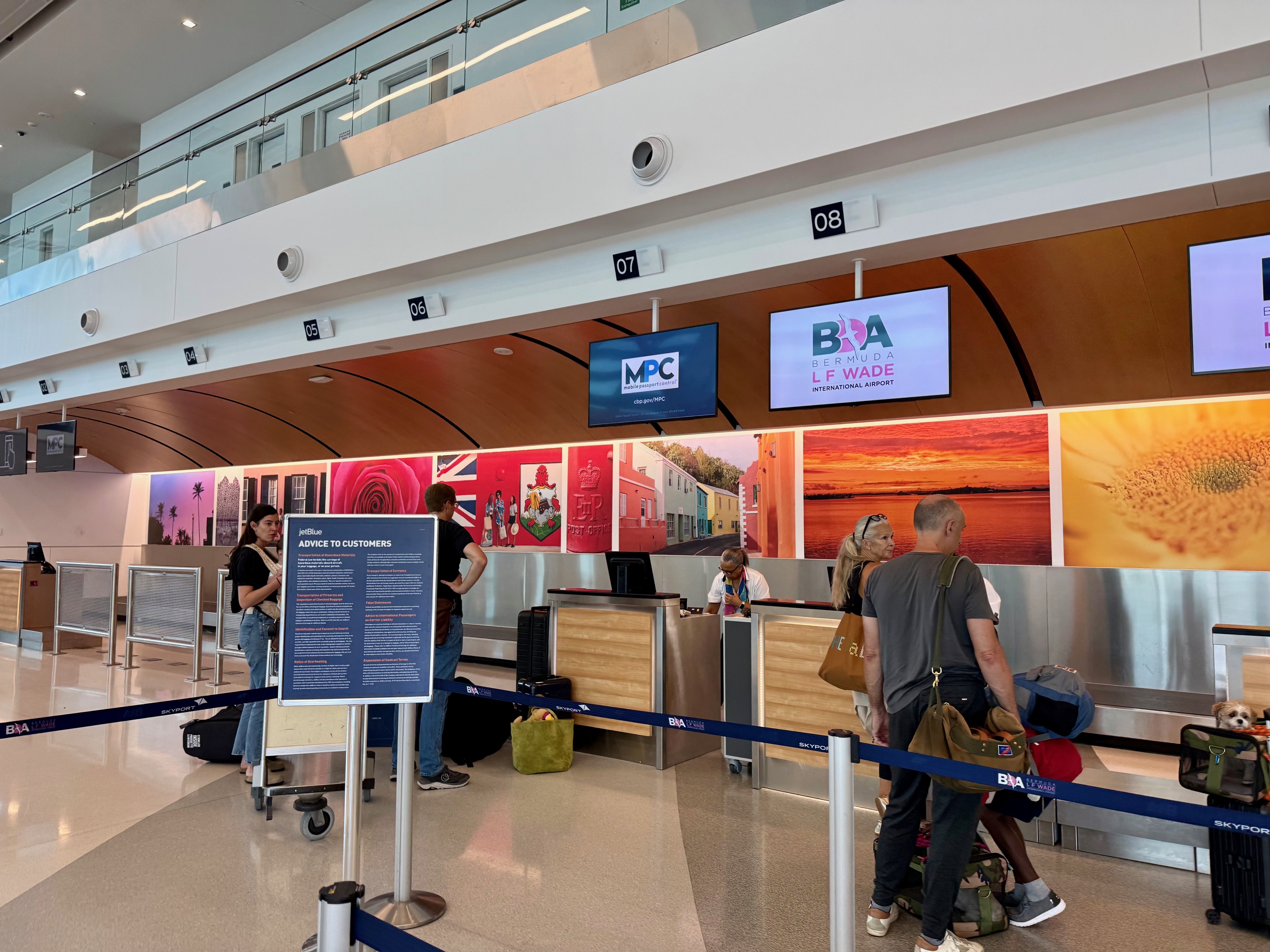 people standing in a line at the BermudAir Check-In line