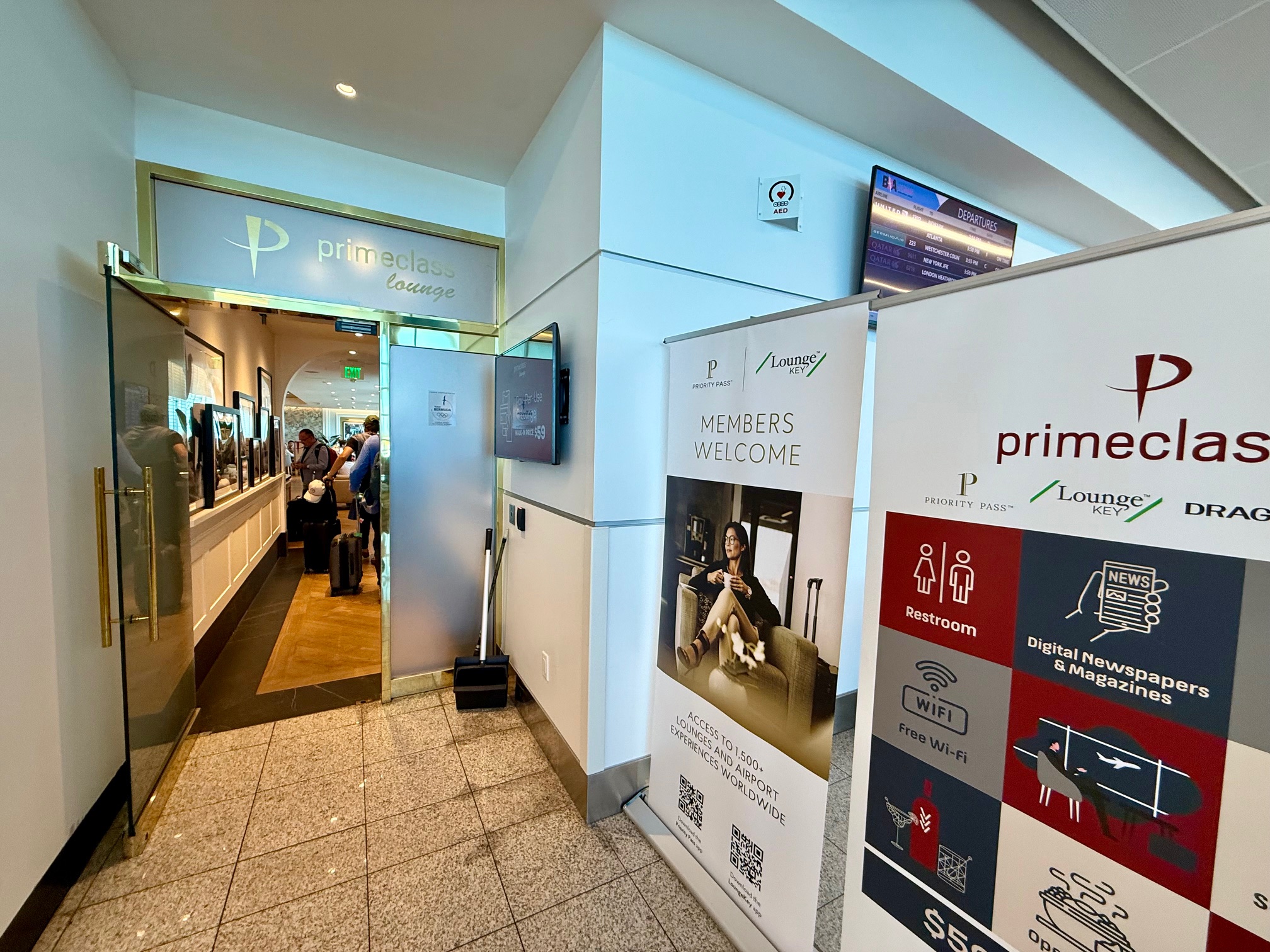 a hallway with signs and people walking