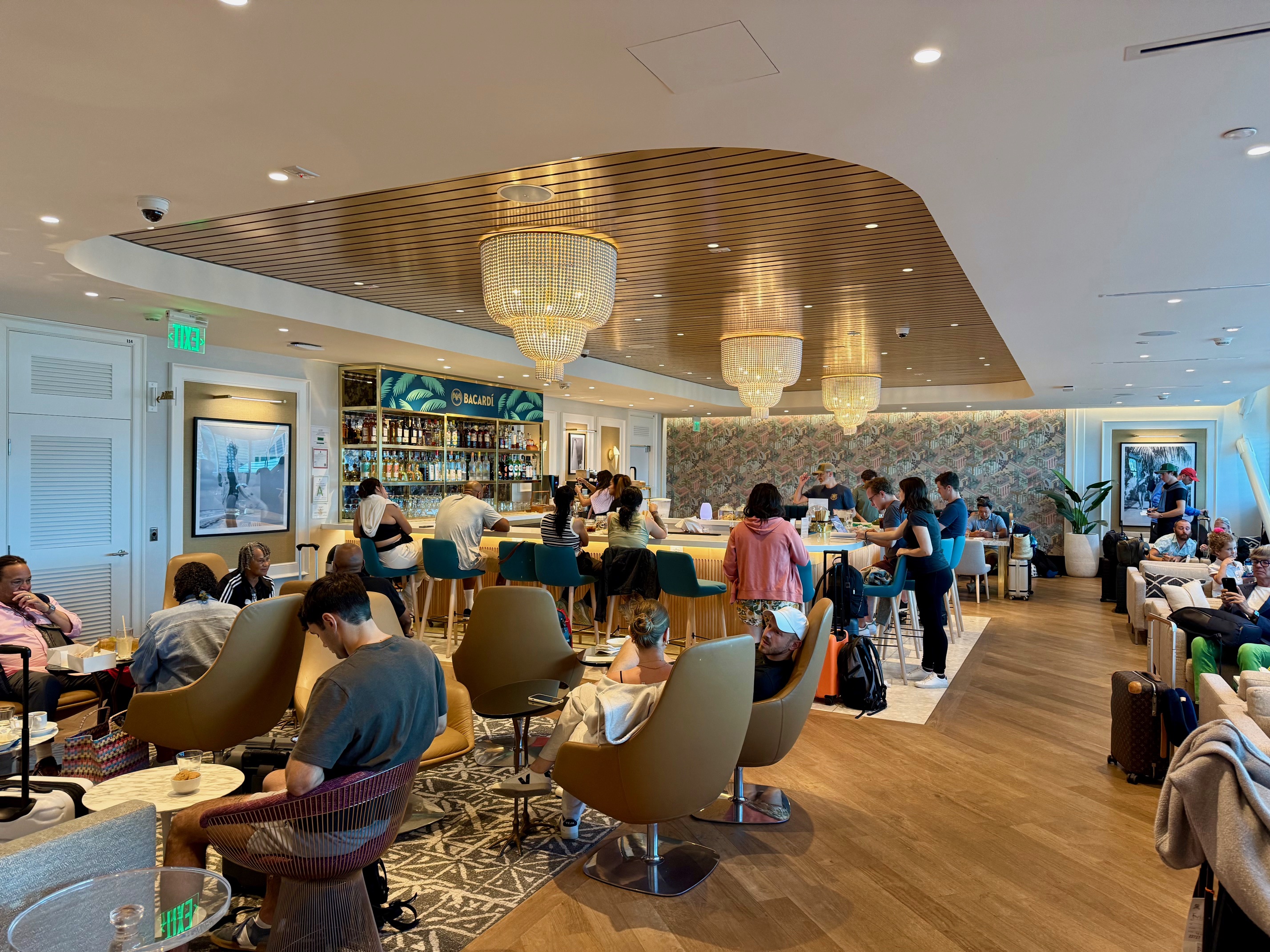 a group of people sitting at tables in the Primeclass Lounge Bermuda Airport