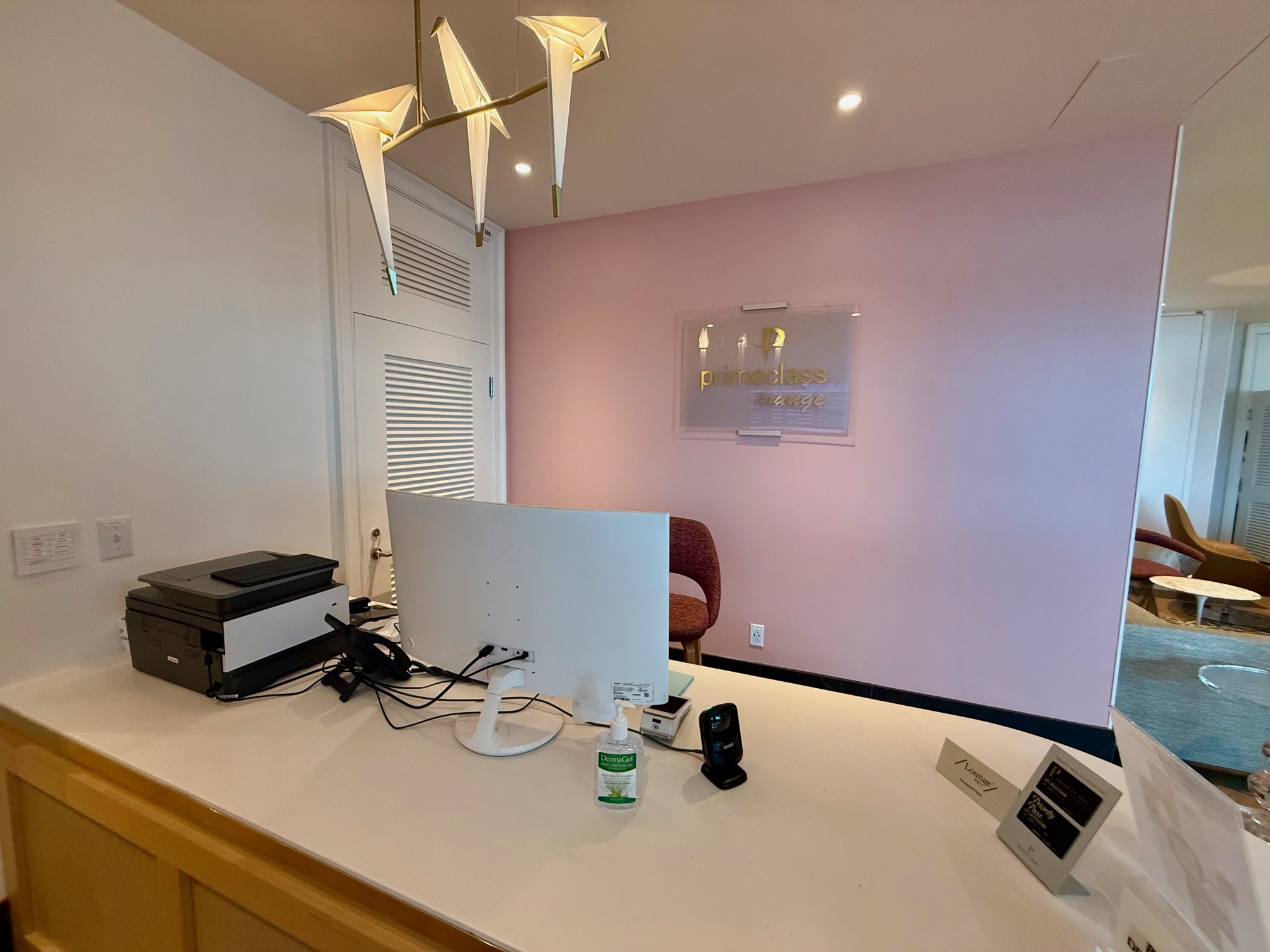 a desk with a computer and a printer