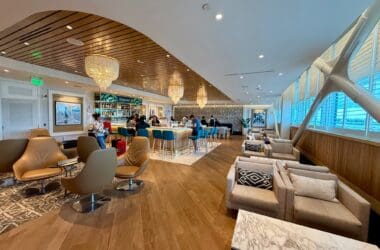a room with a bar and chairs at the Primeclass Lounge Bermuda Airport
