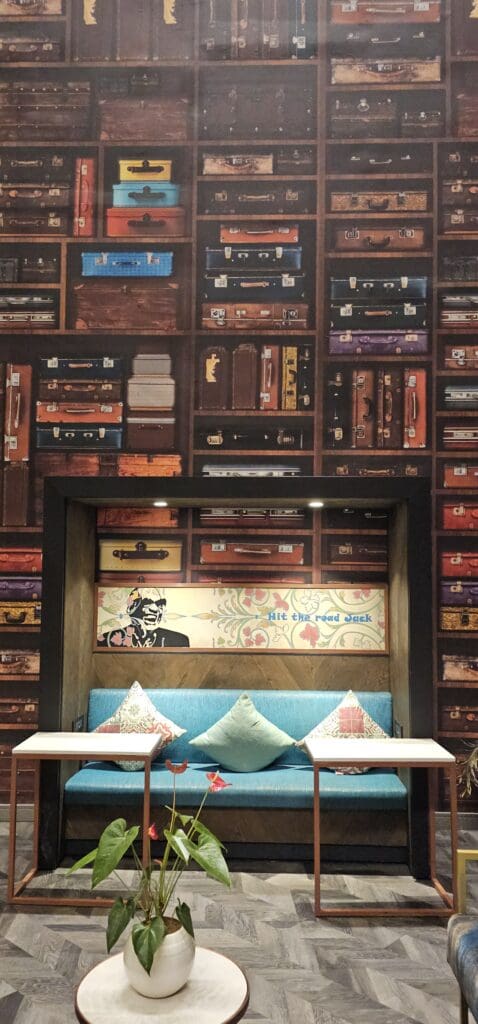 a room with a wall of suitcases