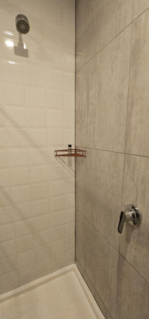 a shower with a shower head and a shower head
