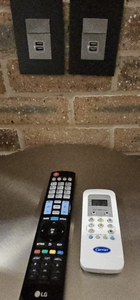 a remote control next to a brick wall