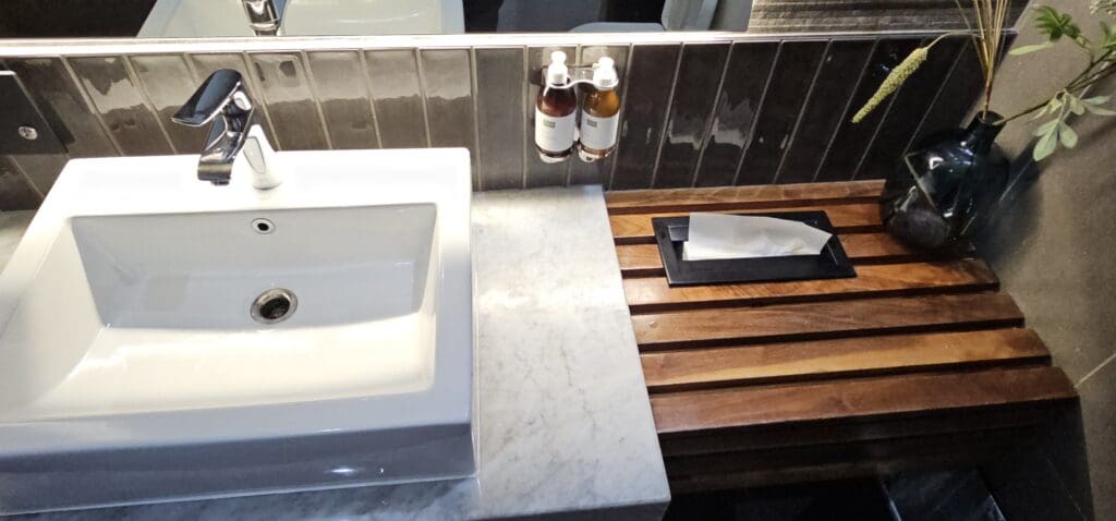 a bathroom sink and soap dispenser