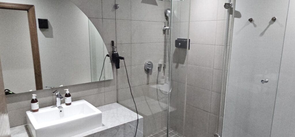 a bathroom with a shower and sink