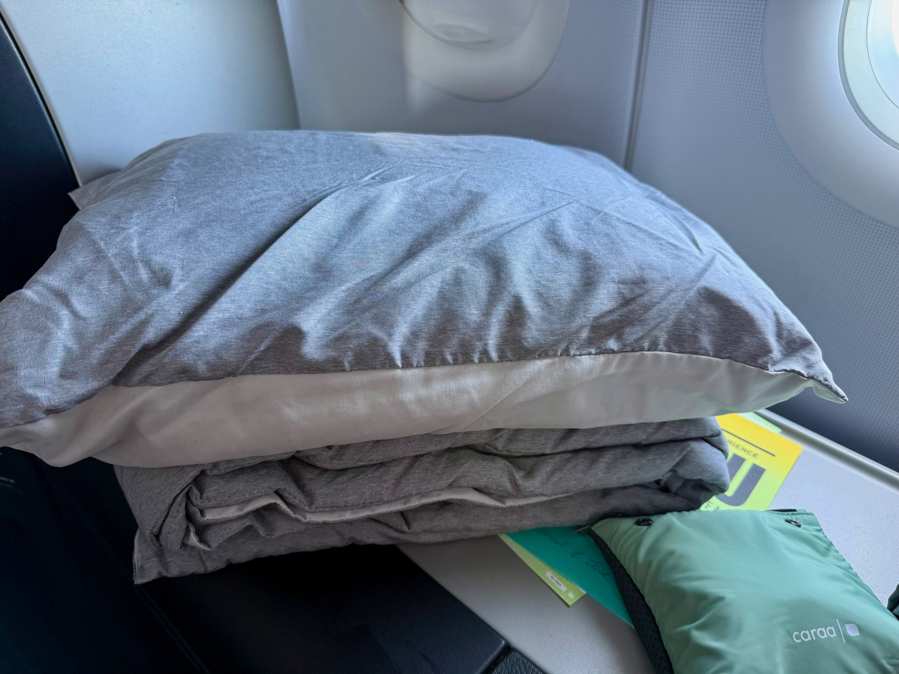 a stack of blankets on a plane