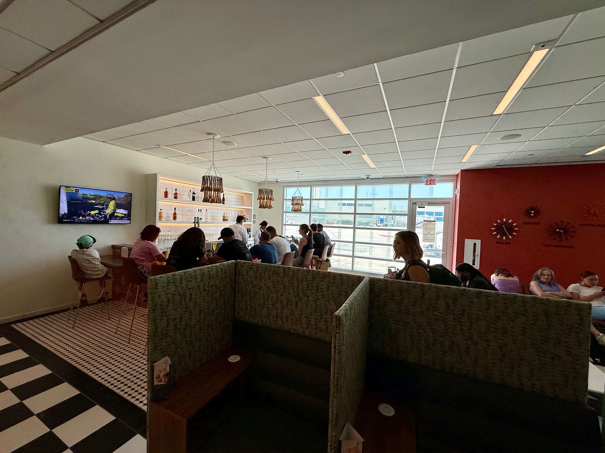 a group of people sitting in a room with a television at the Escape Lounge San Juan