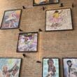 a group of framed pictures on a brick wall