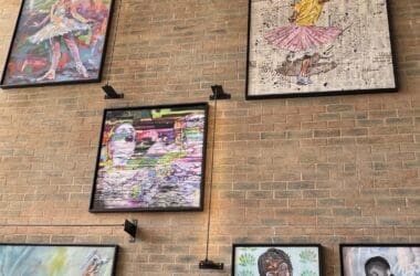 a group of framed pictures on a brick wall