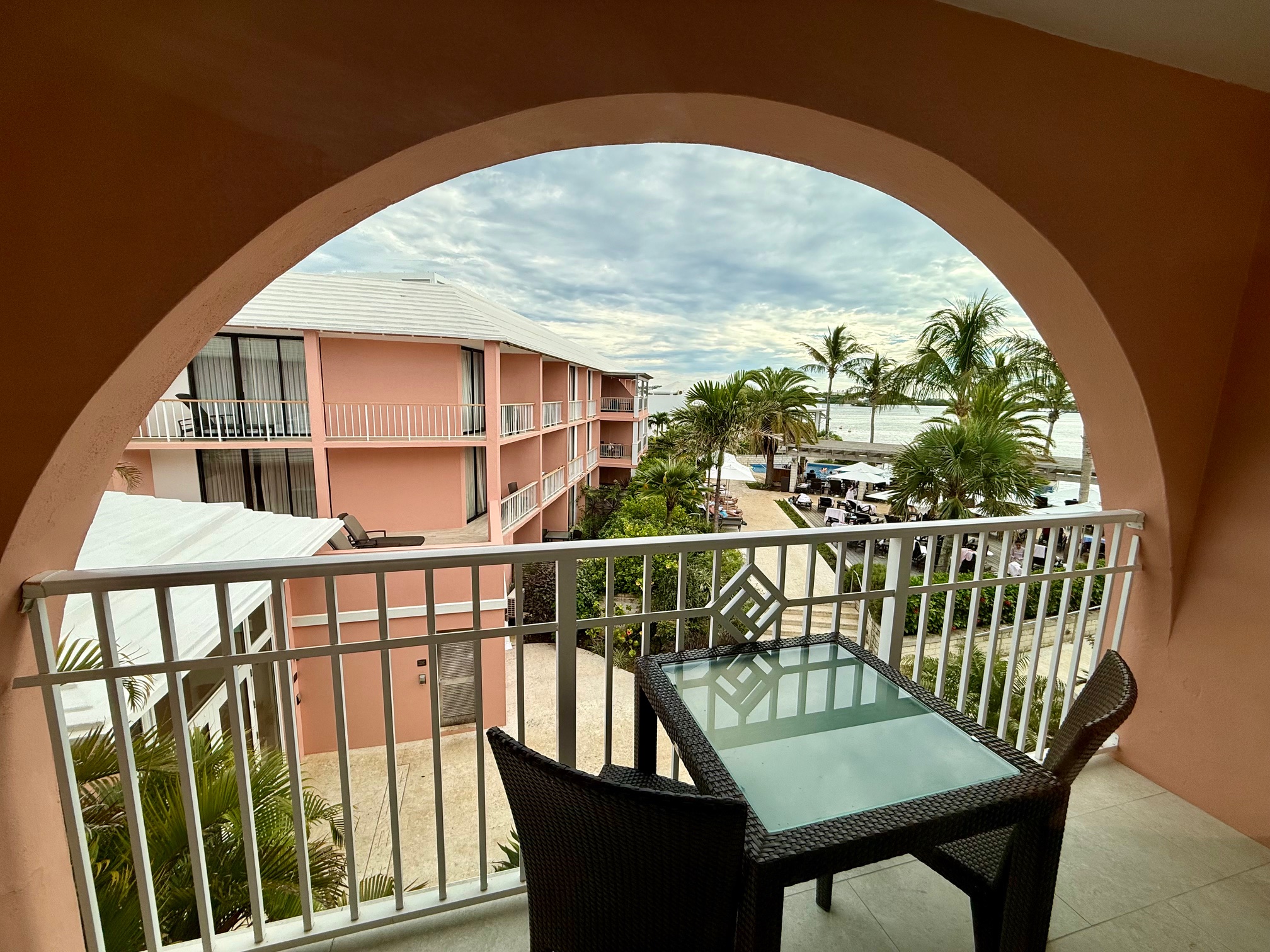 a balcony with a table and chairs