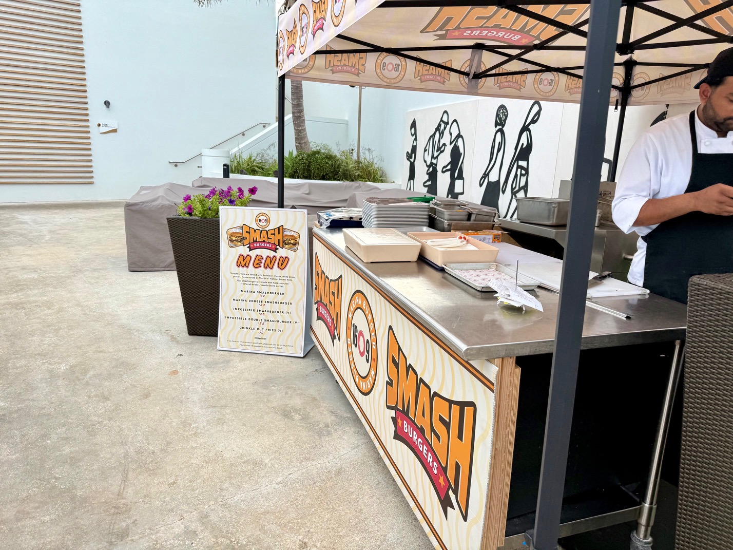 a food stand outside with a person standing behind it