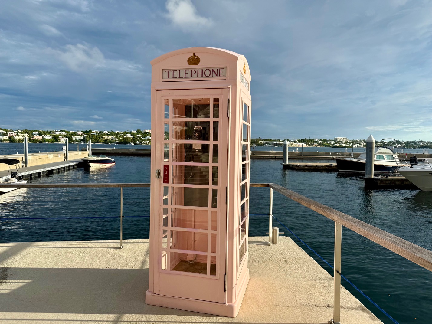 a pink telephone booth on a dock at the Fairmont Hamilton Princess