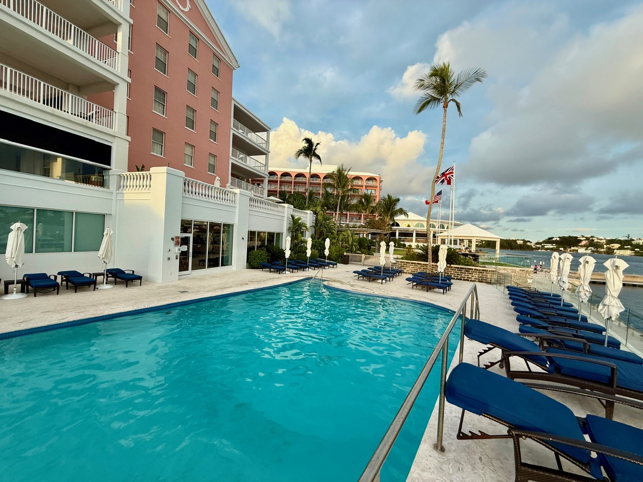 a pool with lounge chairs at the Fairmont Hamilton Princess