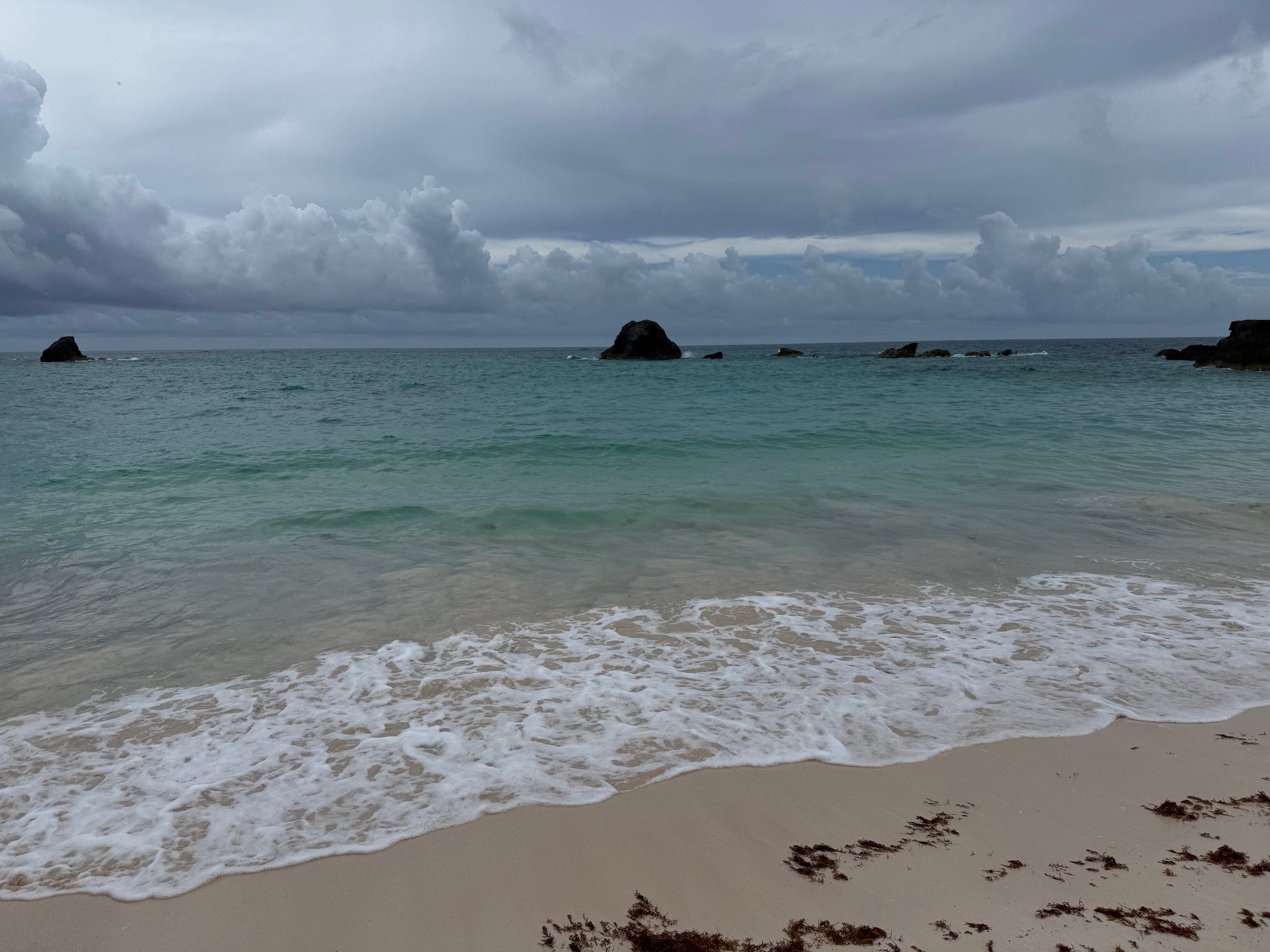 a beach with waves and rocks