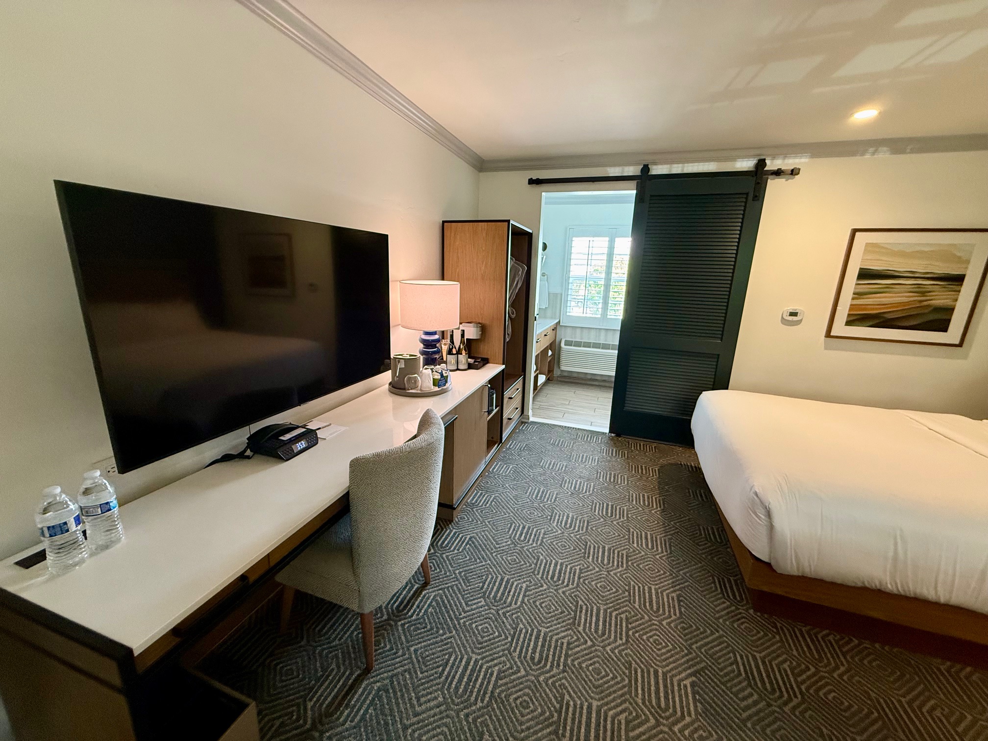 a room with a bed and a tv