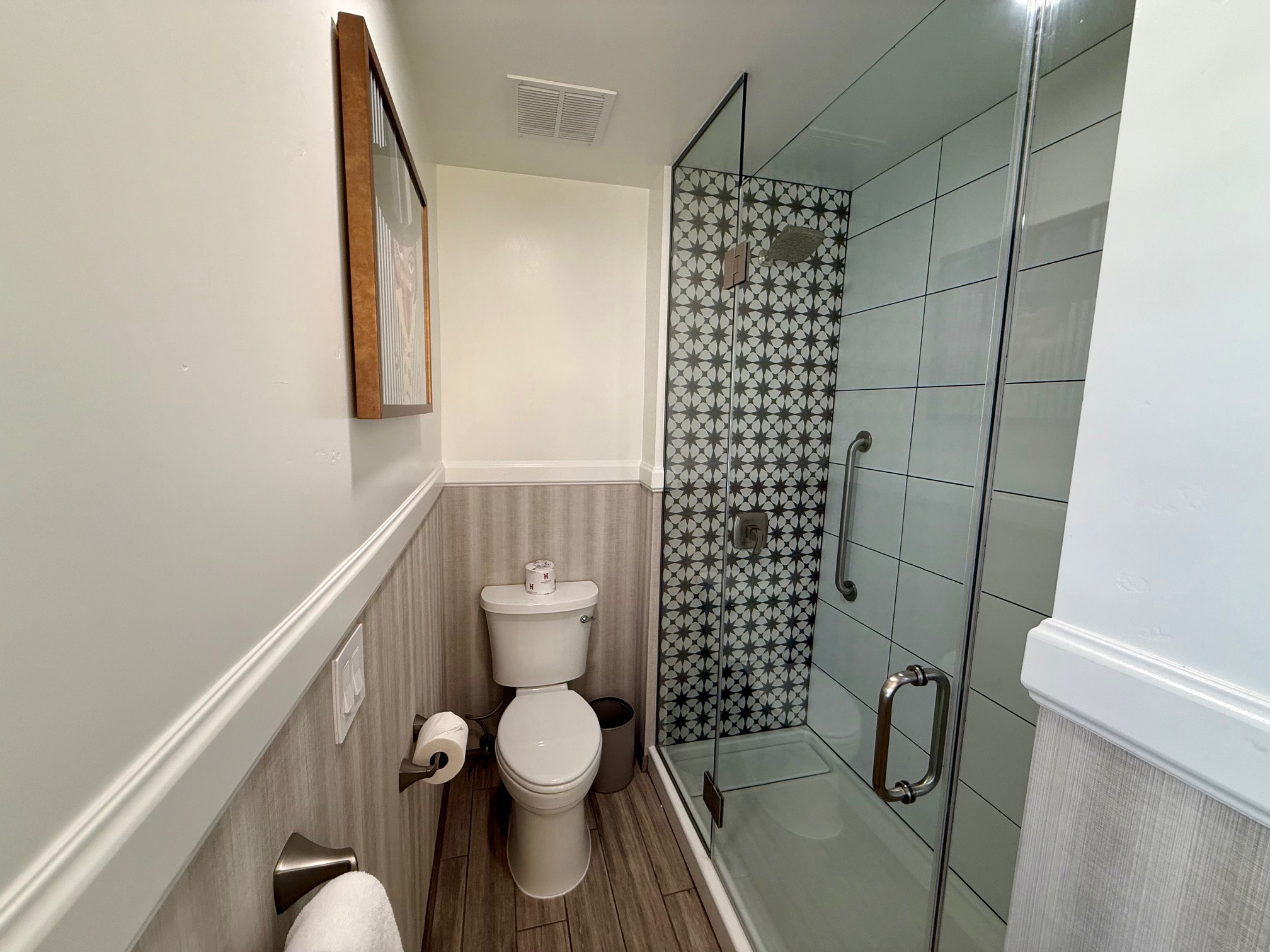 a bathroom with a glass shower and toilet at the Hadsten Solvang
