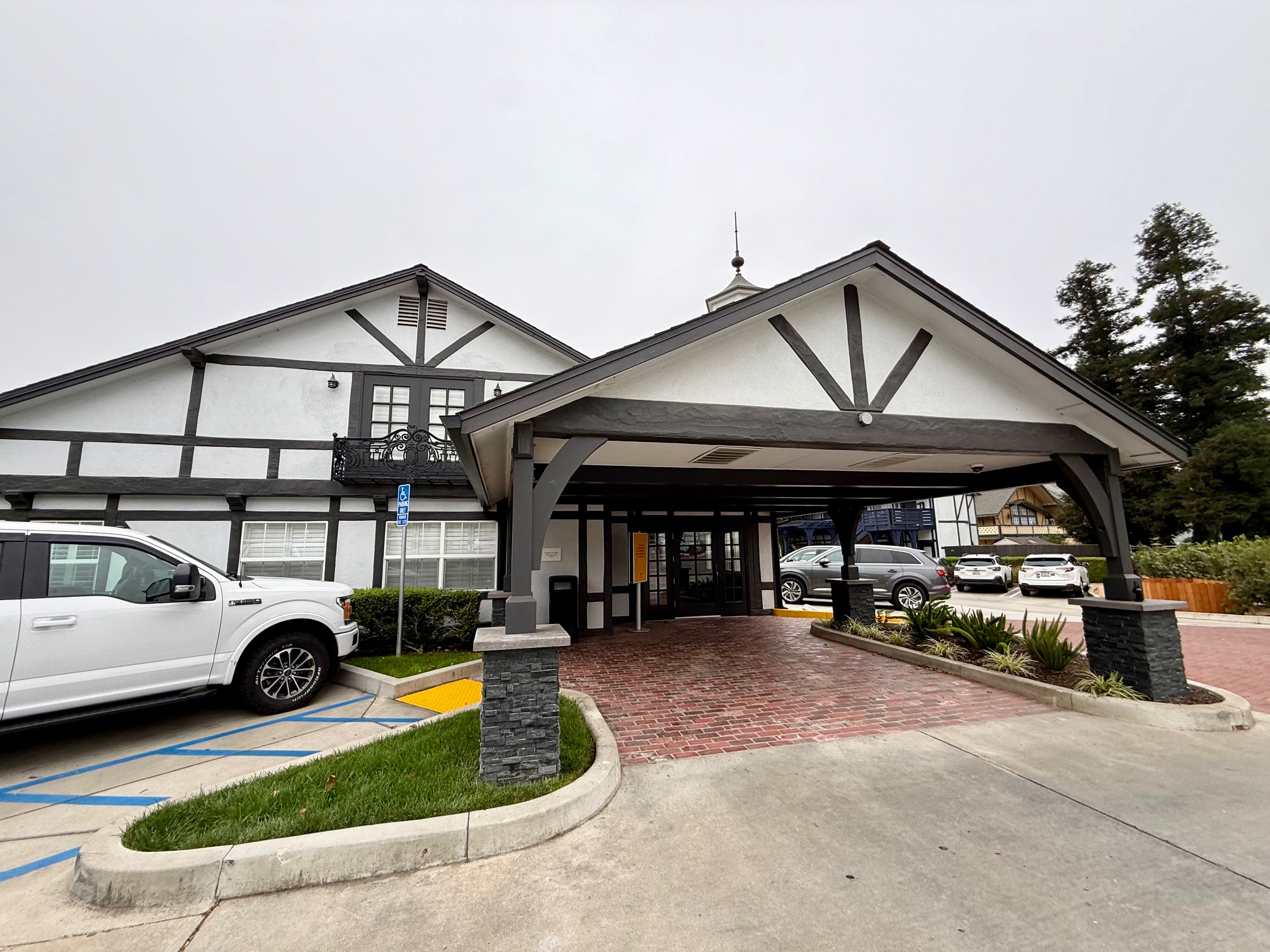 a building with a roof and a car parked in front of it