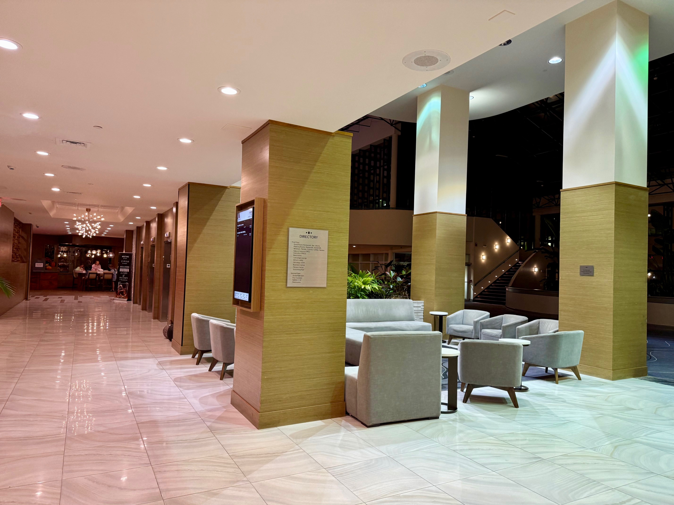a lobby with columns and chairs