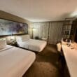 a room with two beds and a desk at the Marriott Melville Long Island
