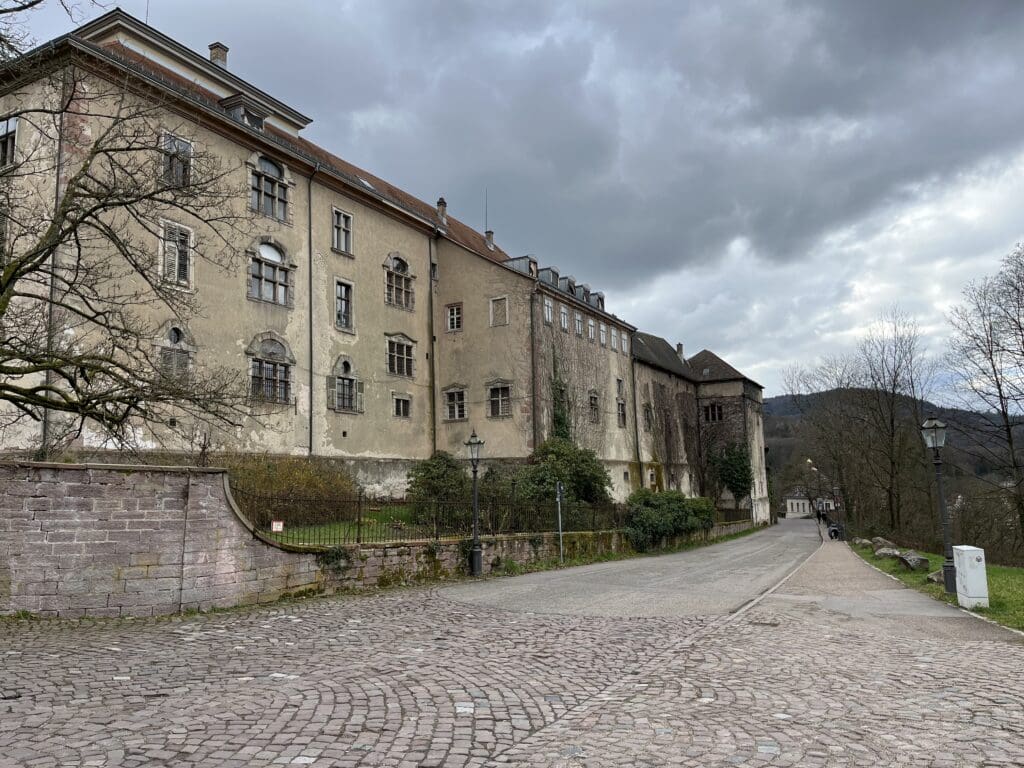 a stone road with a building on the side