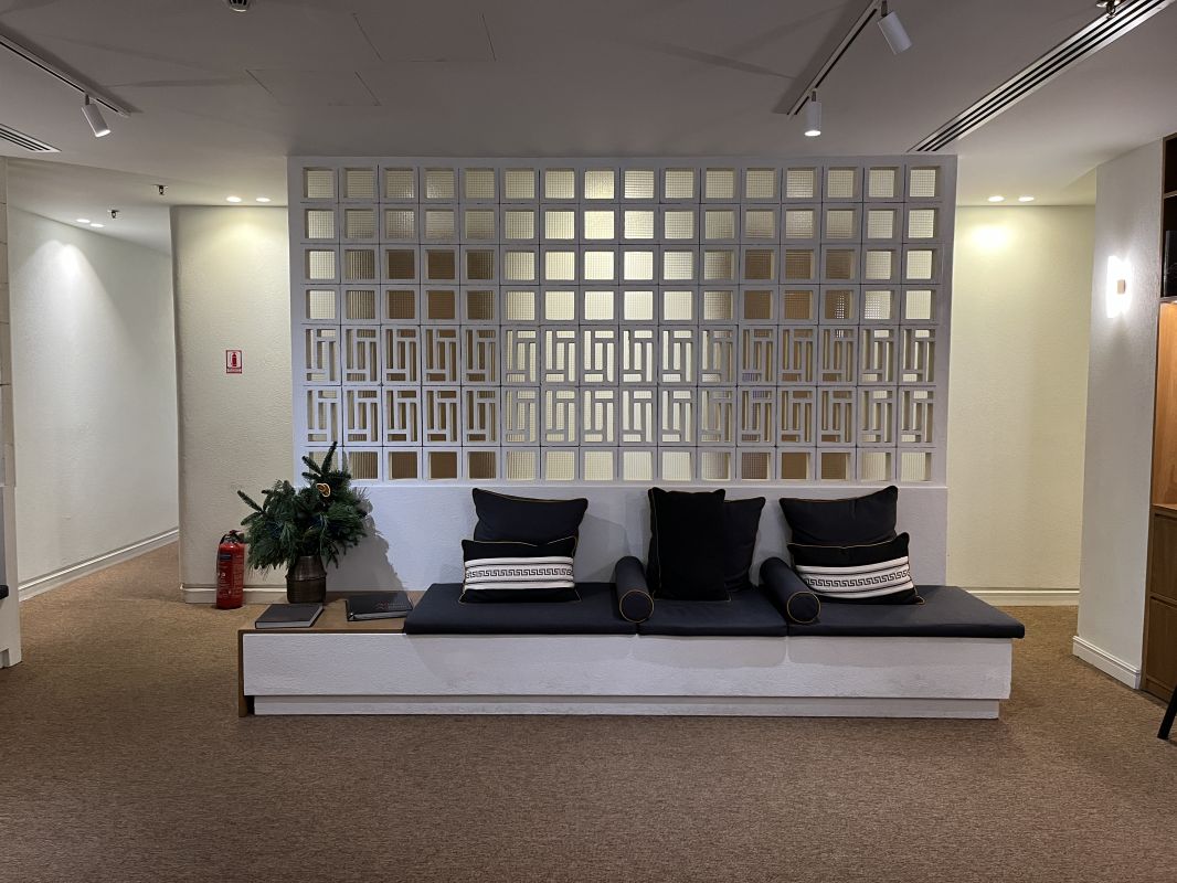 a room with a white wall and a black and white couch