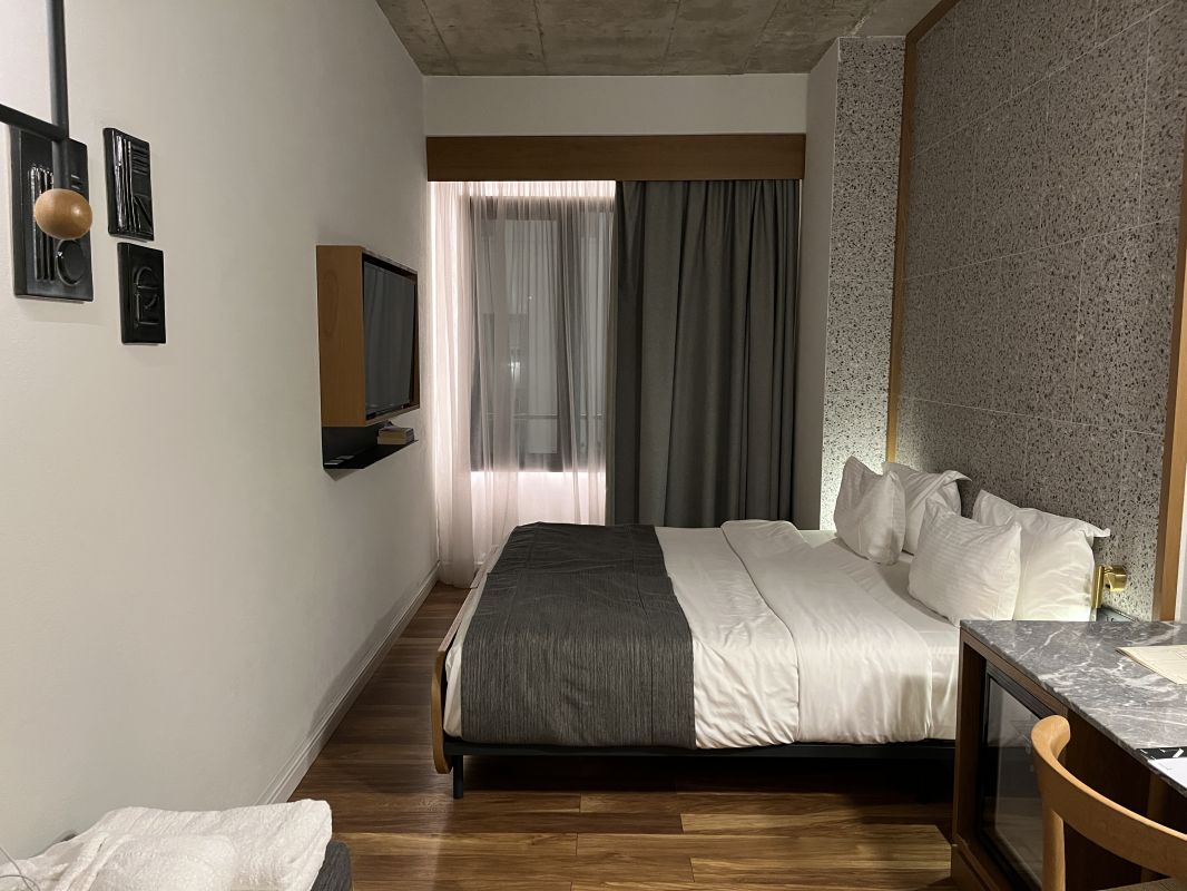 a room with a bed and a television