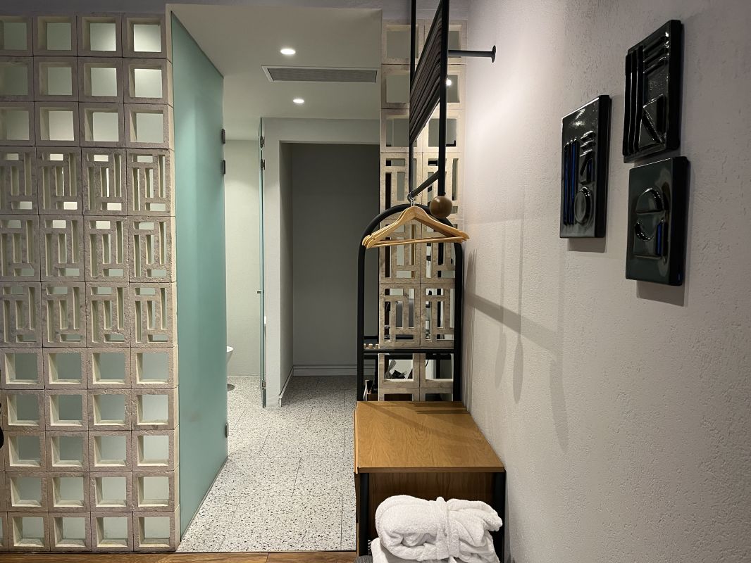 a room with a coat rack and a towel rack