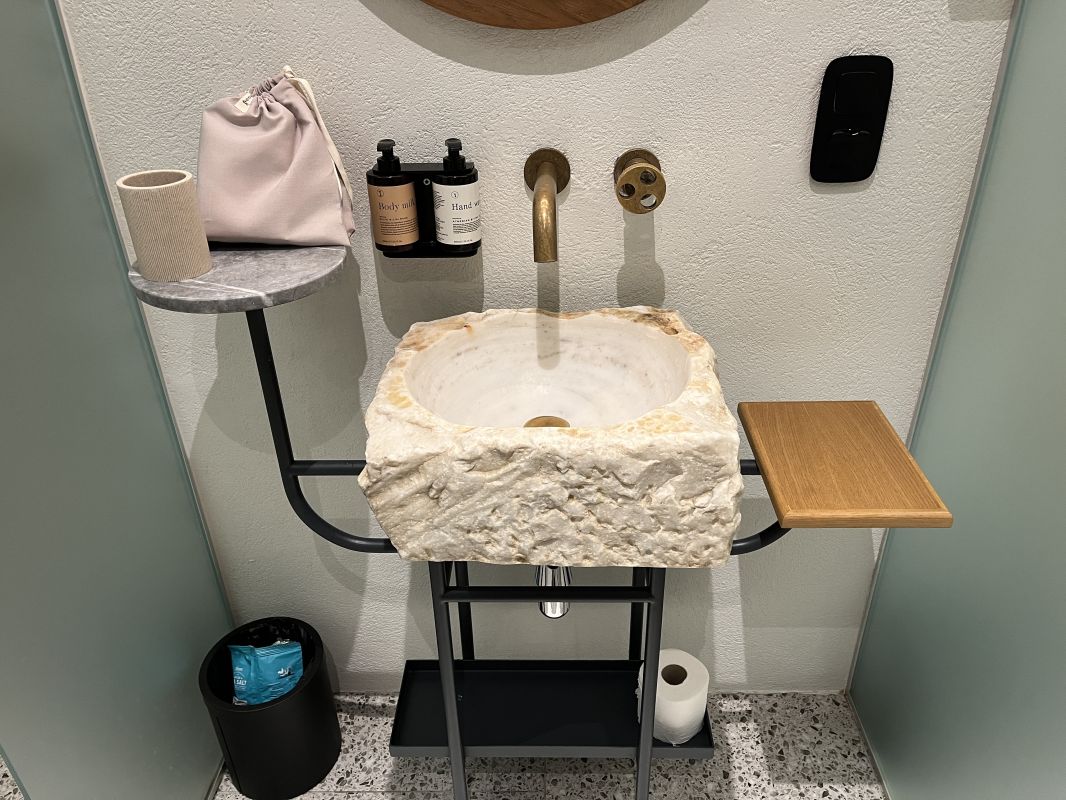 a sink with a faucet and a towel on the wall