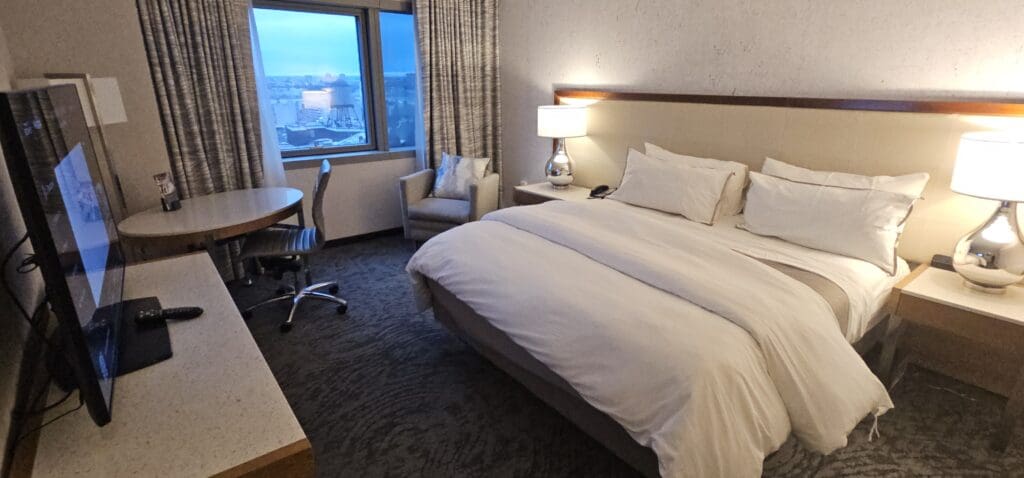 a hotel room with a bed and chairs