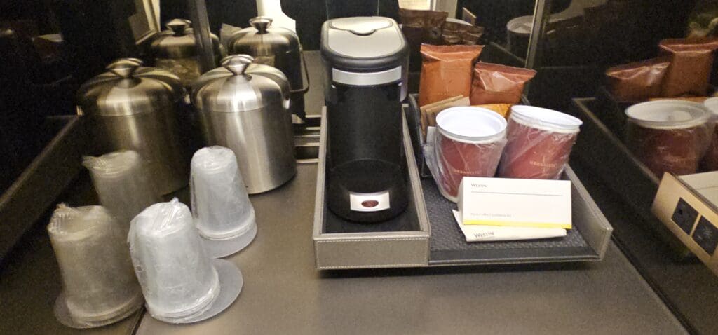 a coffee maker and other items on a tray