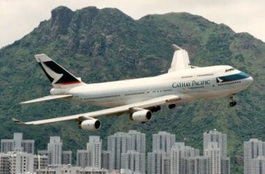 a large airplane flying over a city