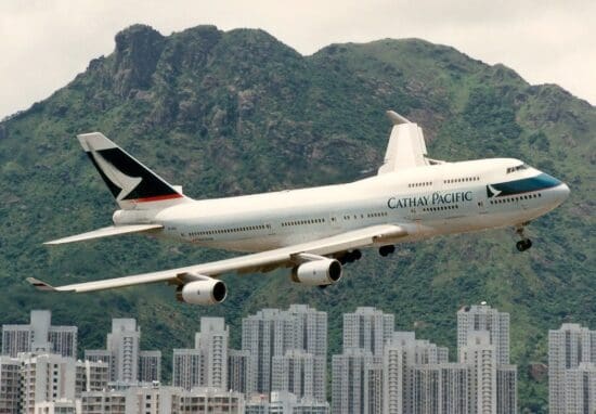 a large airplane flying over a city