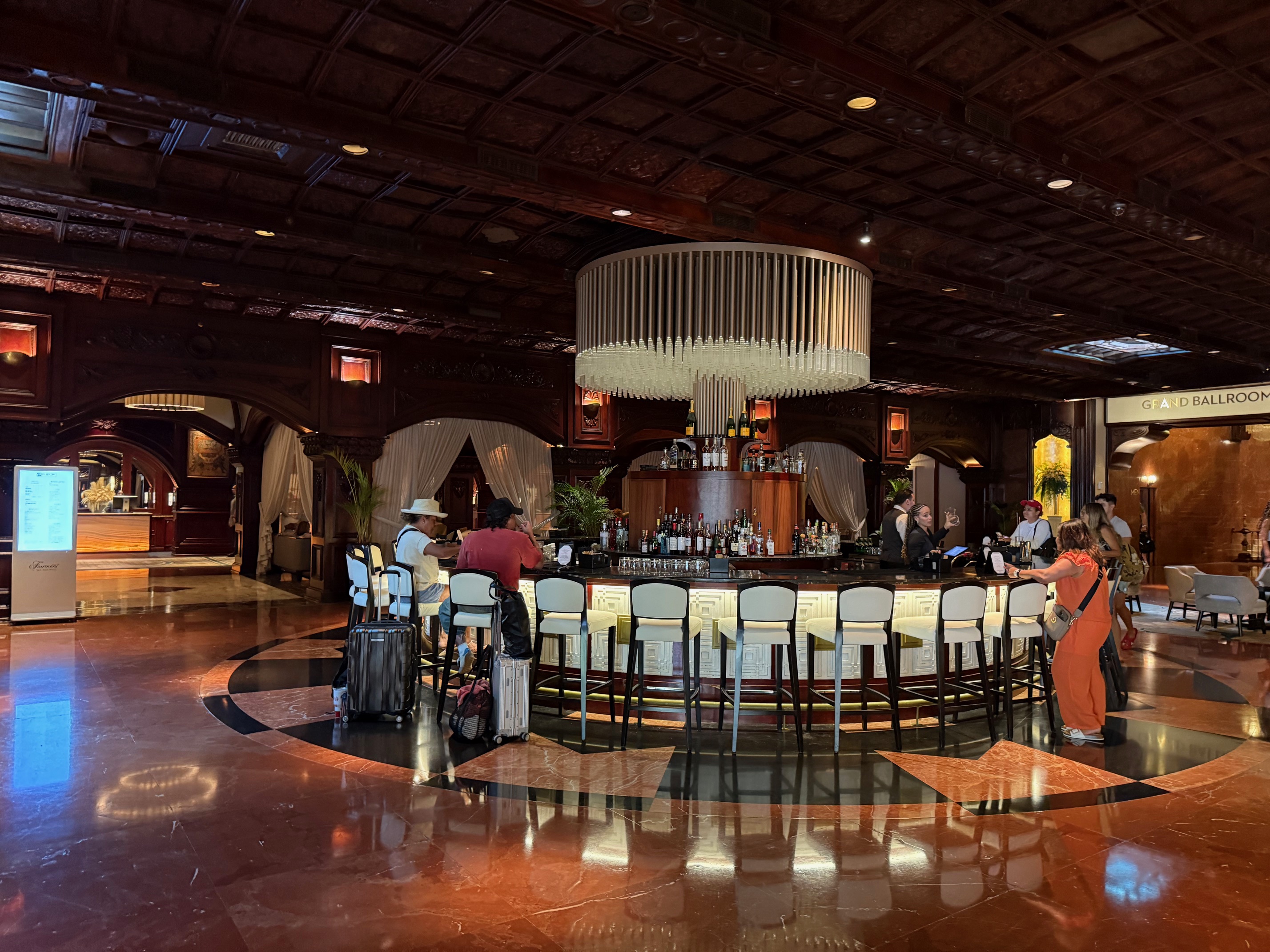 a group of people standing around a bar