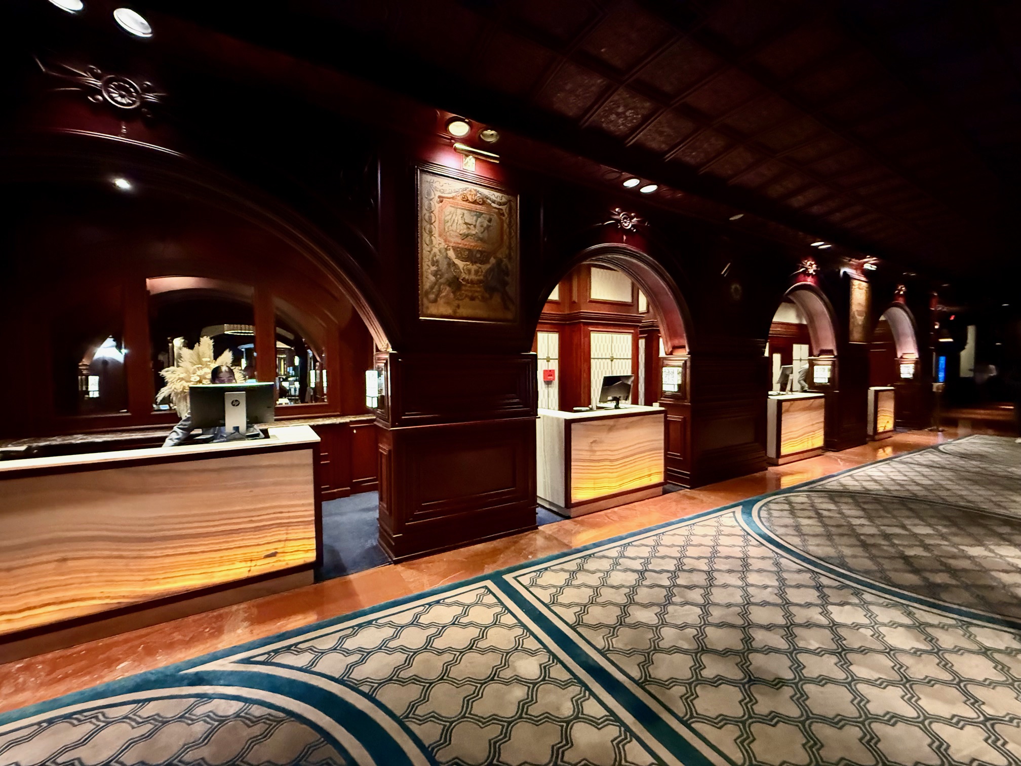 a hallway with a reception desk and a carpet