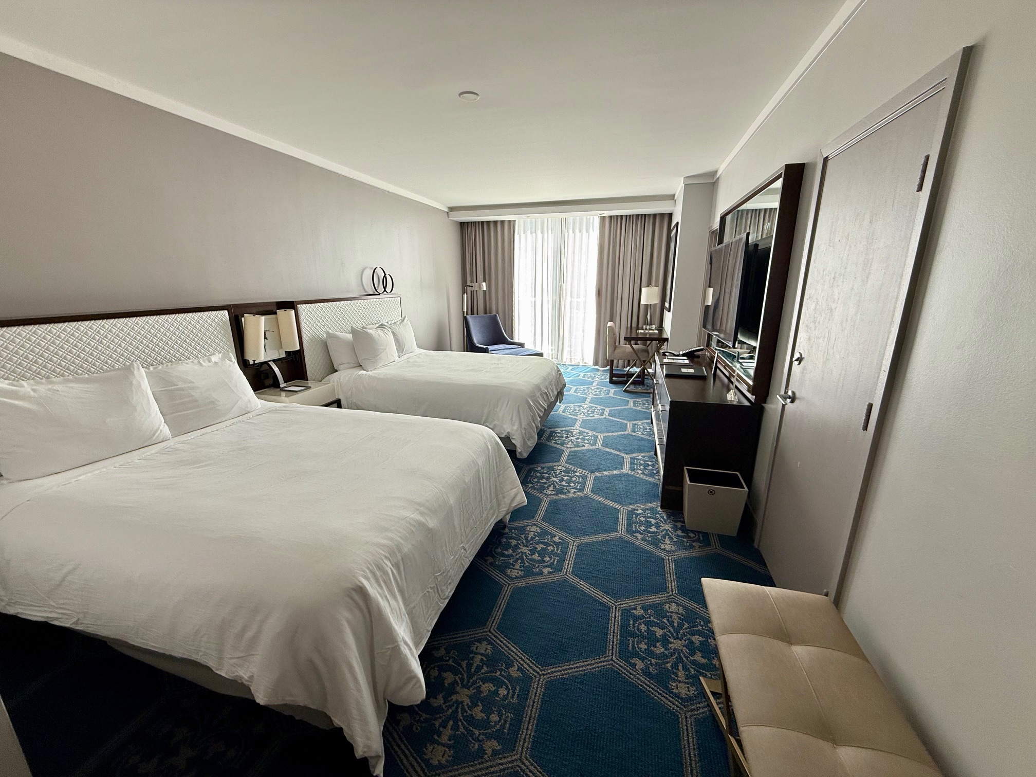 a room with two beds and a mirror at the Fairmont El San Juan