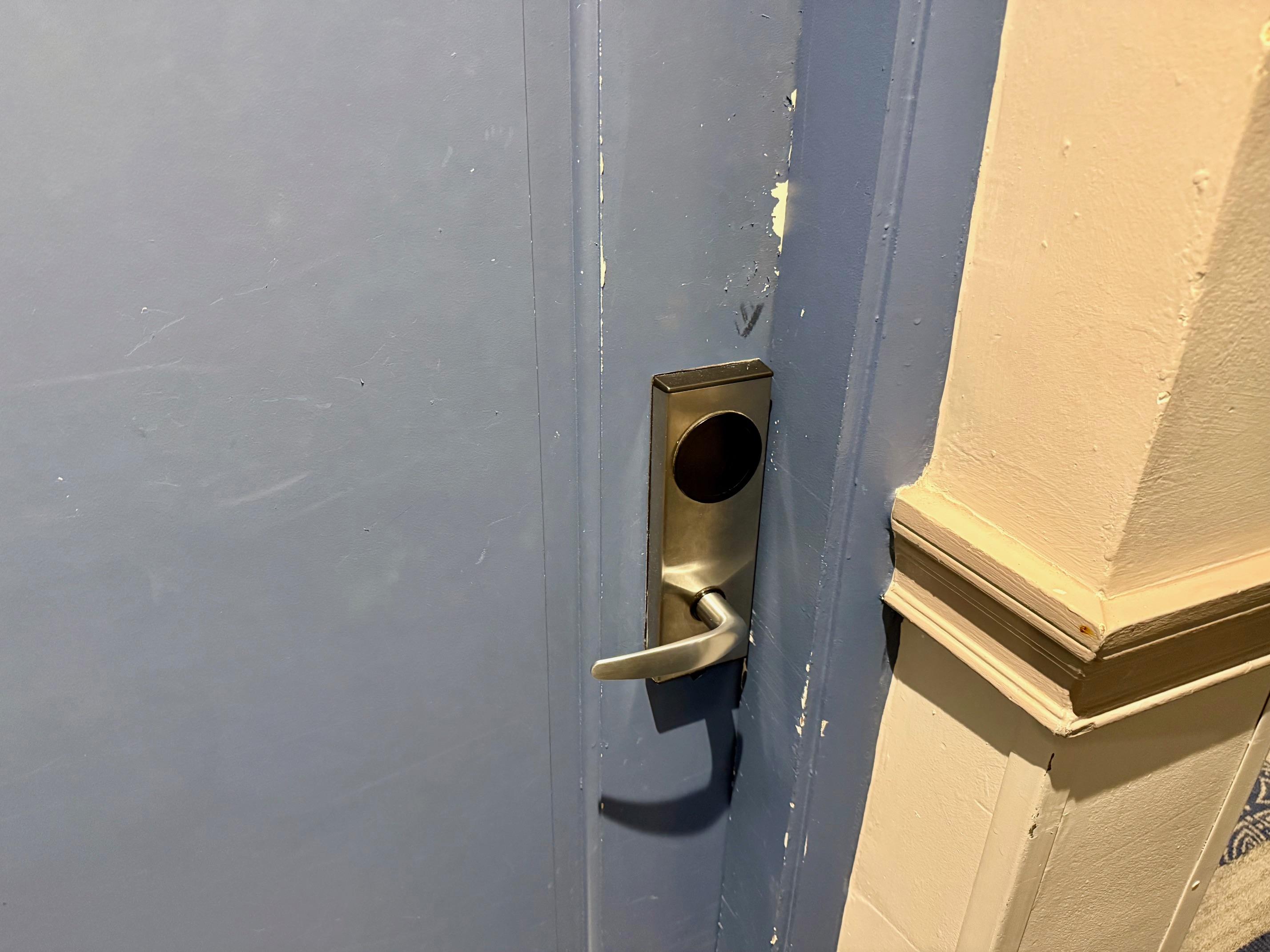 a door handle on a blue door