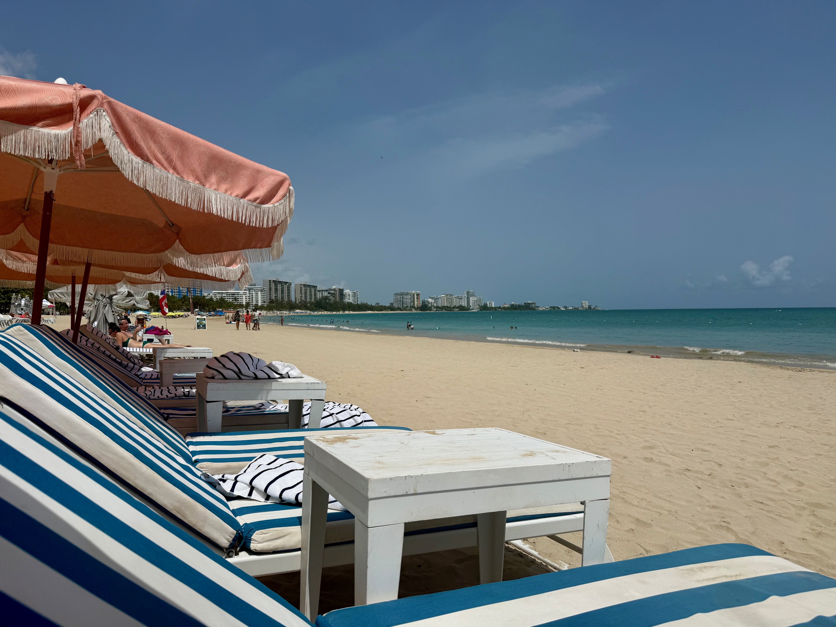 chairs on a beach with umbrellas and chairs at the Fairmont El San Juan