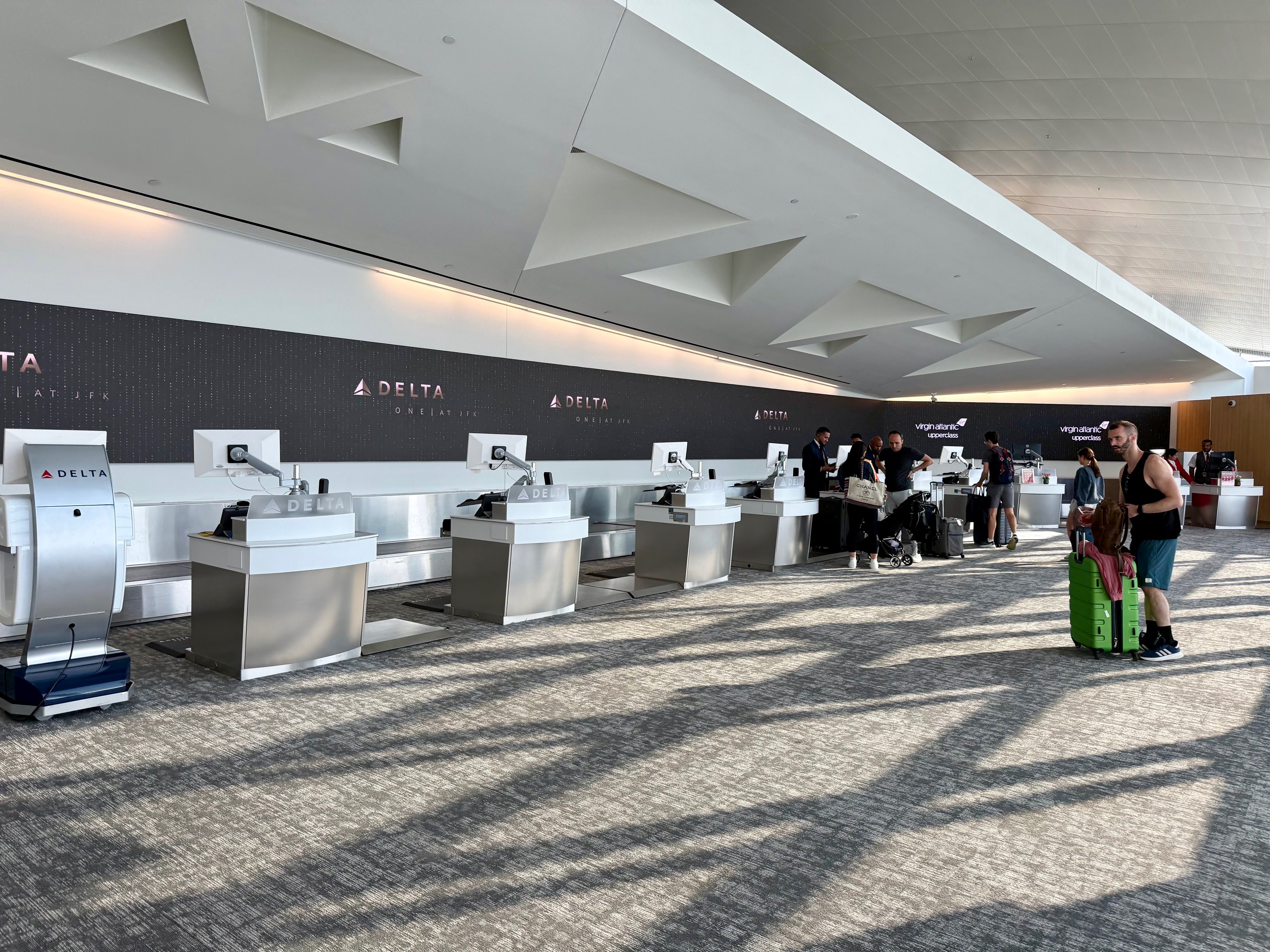 people at an airport check in desks